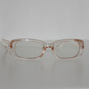 Clear Syren safety glasses viewed from the front on a light grey surface