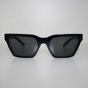 Harlem Black safety glasses with dark tinted lenses, front view on a light grey background
