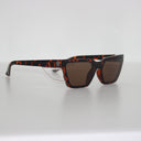 Harlem Brown Tort safety glasses with a clear side shield, side view on a light grey background