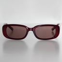 SYREN Crimson safety glasses with polarised brown lenses, front view on a light grey background
